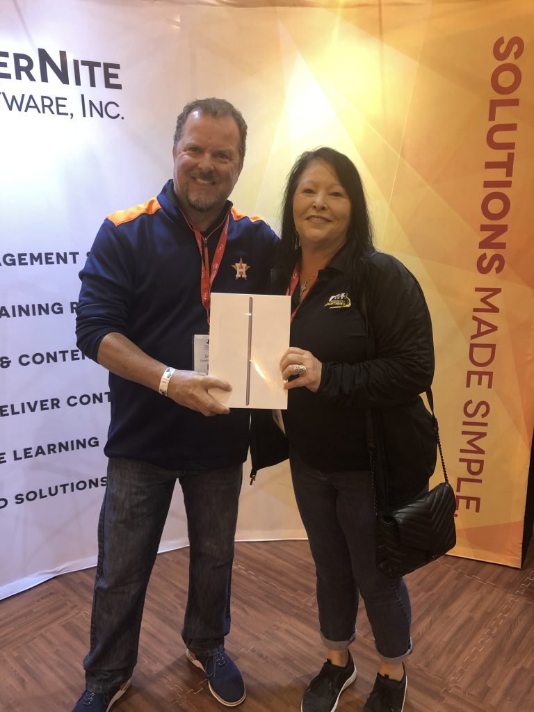 OSI Sales Manager Kevin Snedecor with the winner of an iPad prize at Clean Gulf 2019
